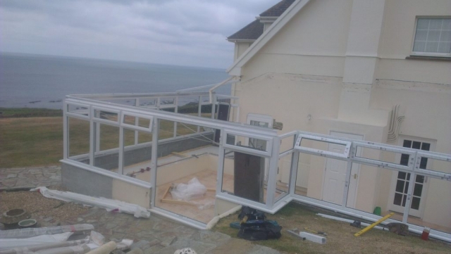 Frames being installed on wrap around conservatory